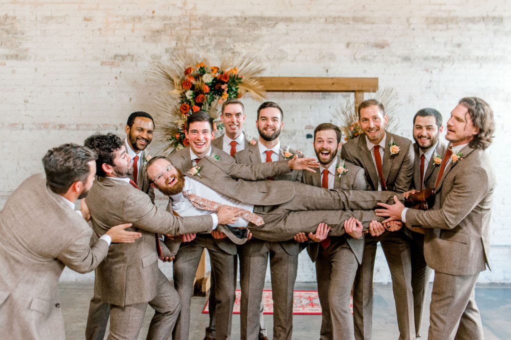 groom posing with groomsmen