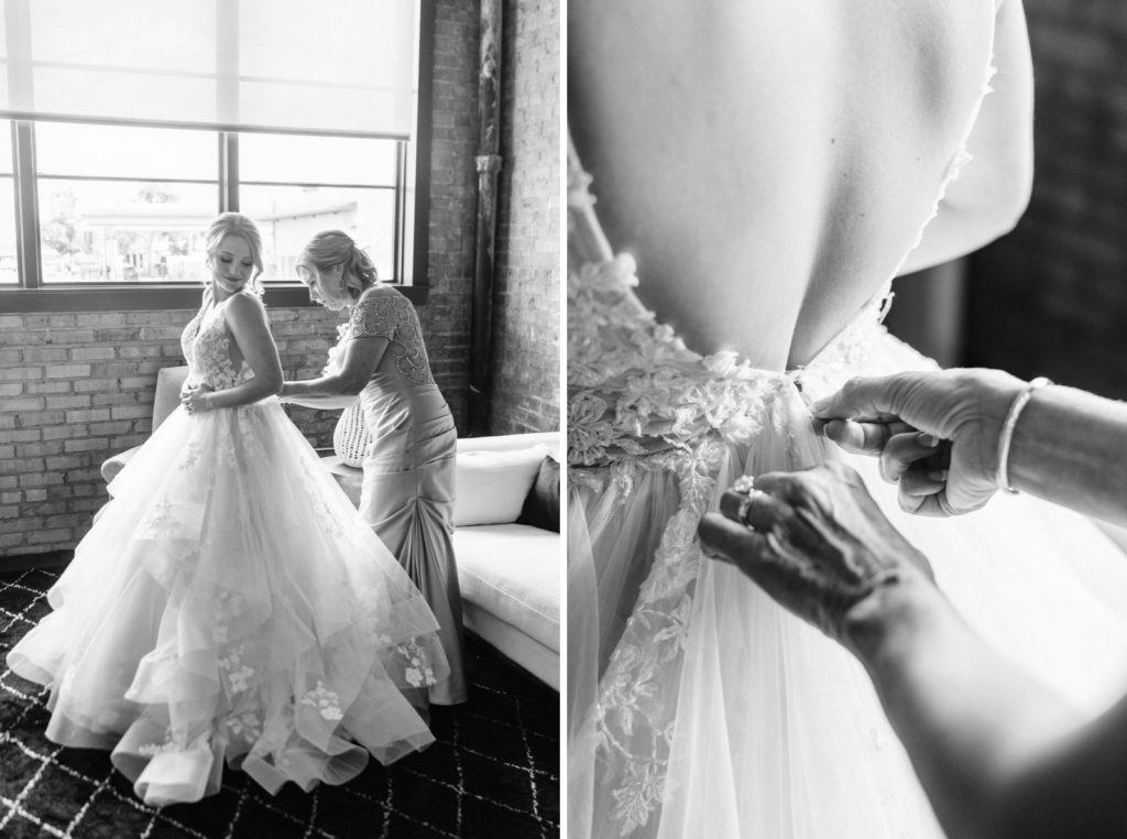 bride getting dressed with help from mom