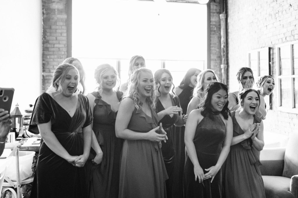 bridesmaids excited to see bride in dress