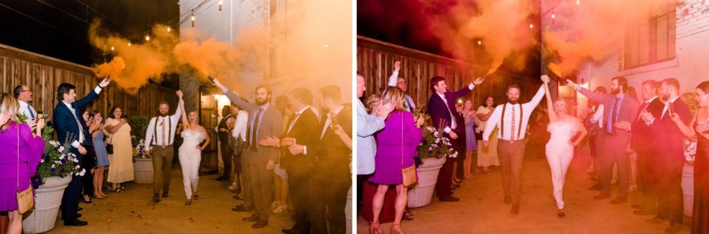 couple exiting reception with smoke bombs and cheering crowd